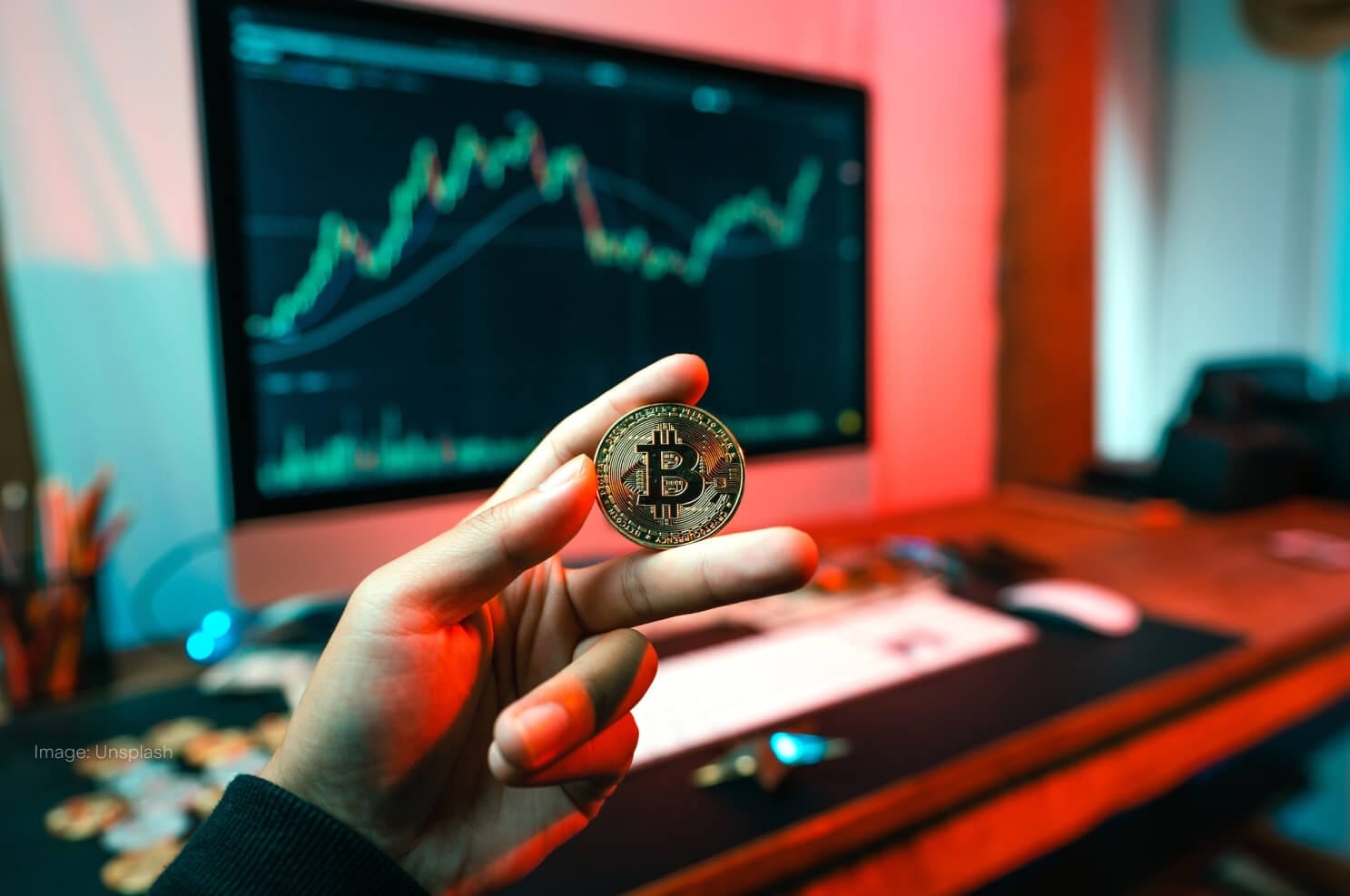 bitcoin-held-in-hand-computer-in-background-bitcoin-etfs-banner.jpg