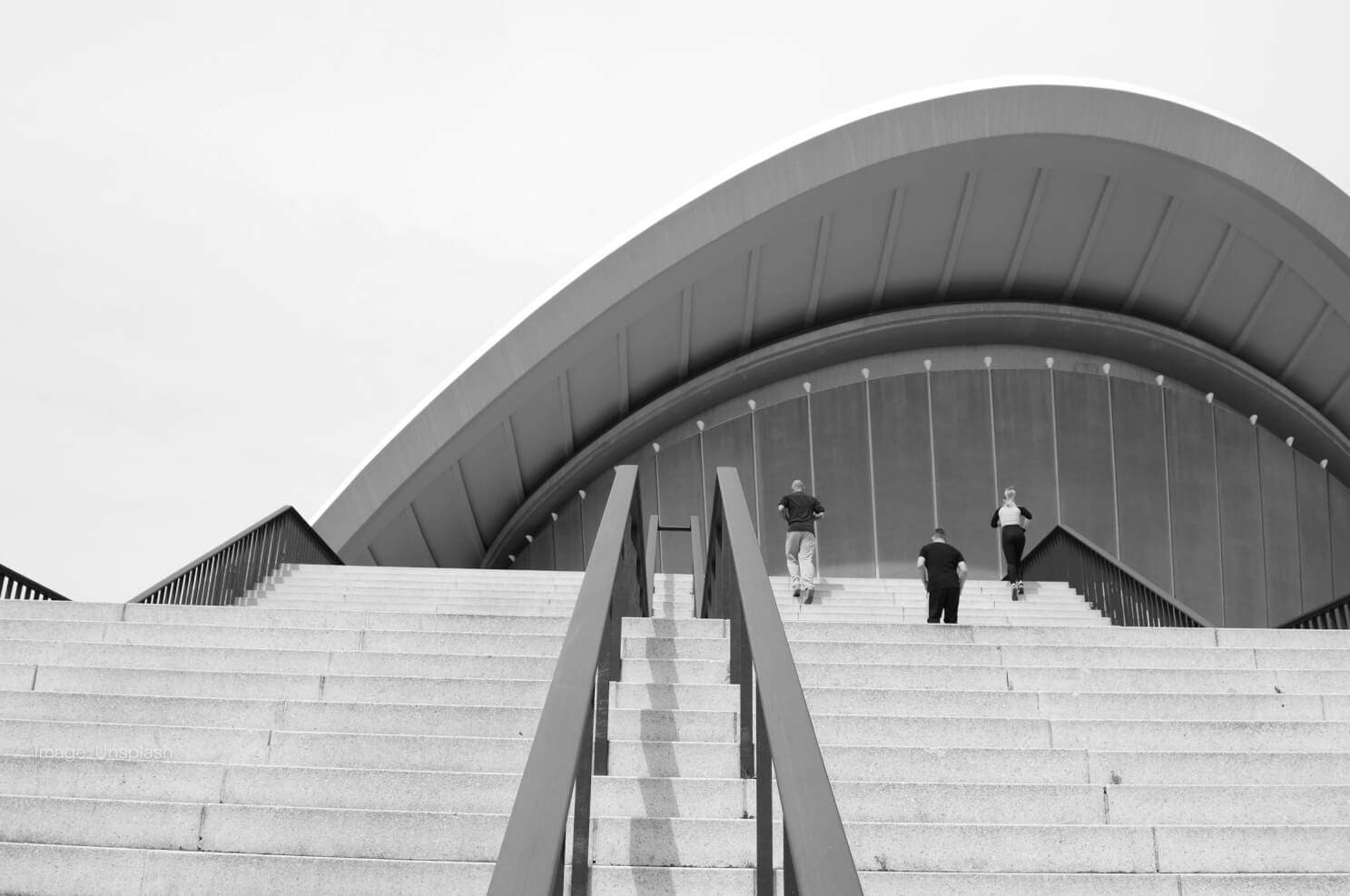 grayscale-people-walking-up-stairs.jpg