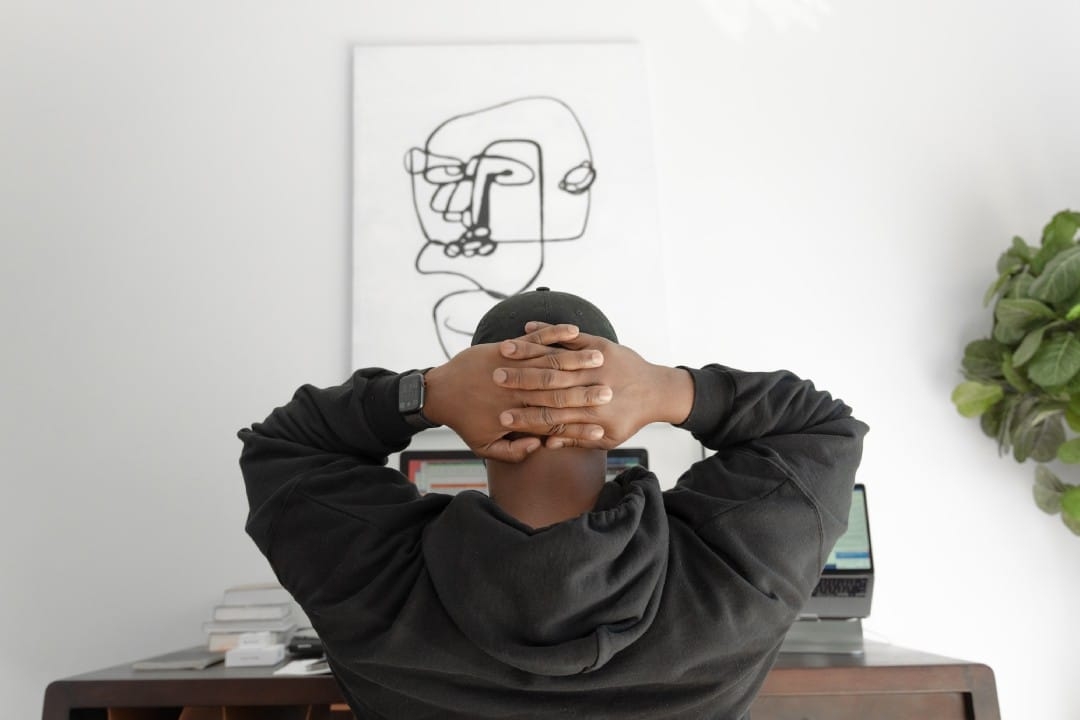man-with-hands-on-head-sitting-at-desk.jpg