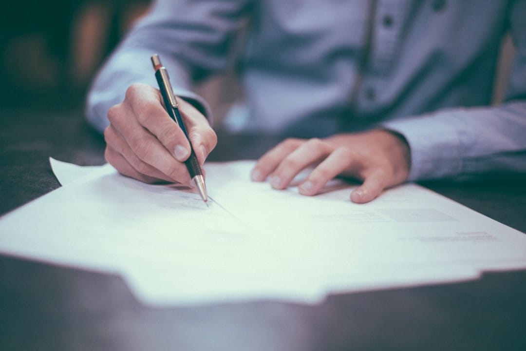 two-hands-writing-with-pen-paper.jpg