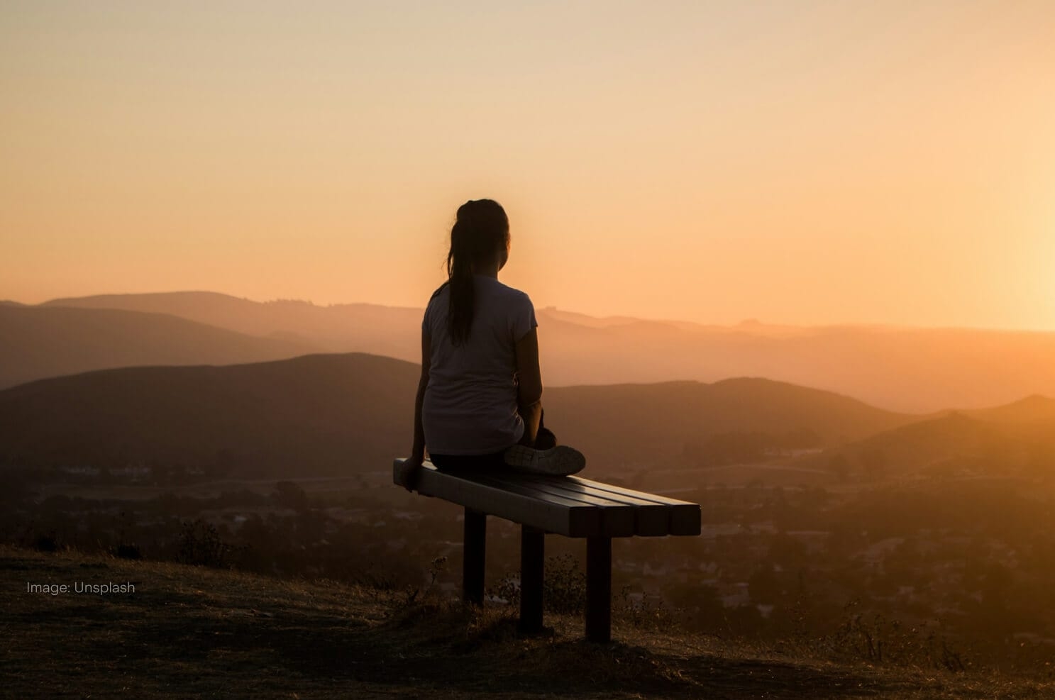 woman-sitting-on-bench-sunset.jpg