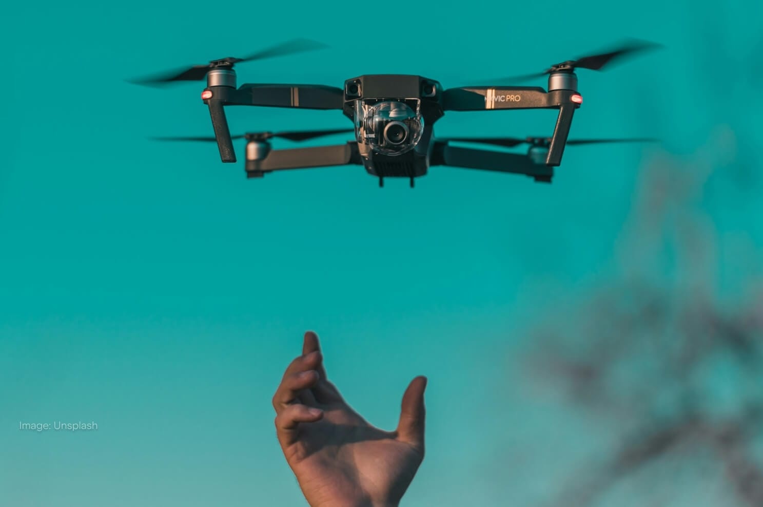 drone-flying-above-hand-in-sky.jpg