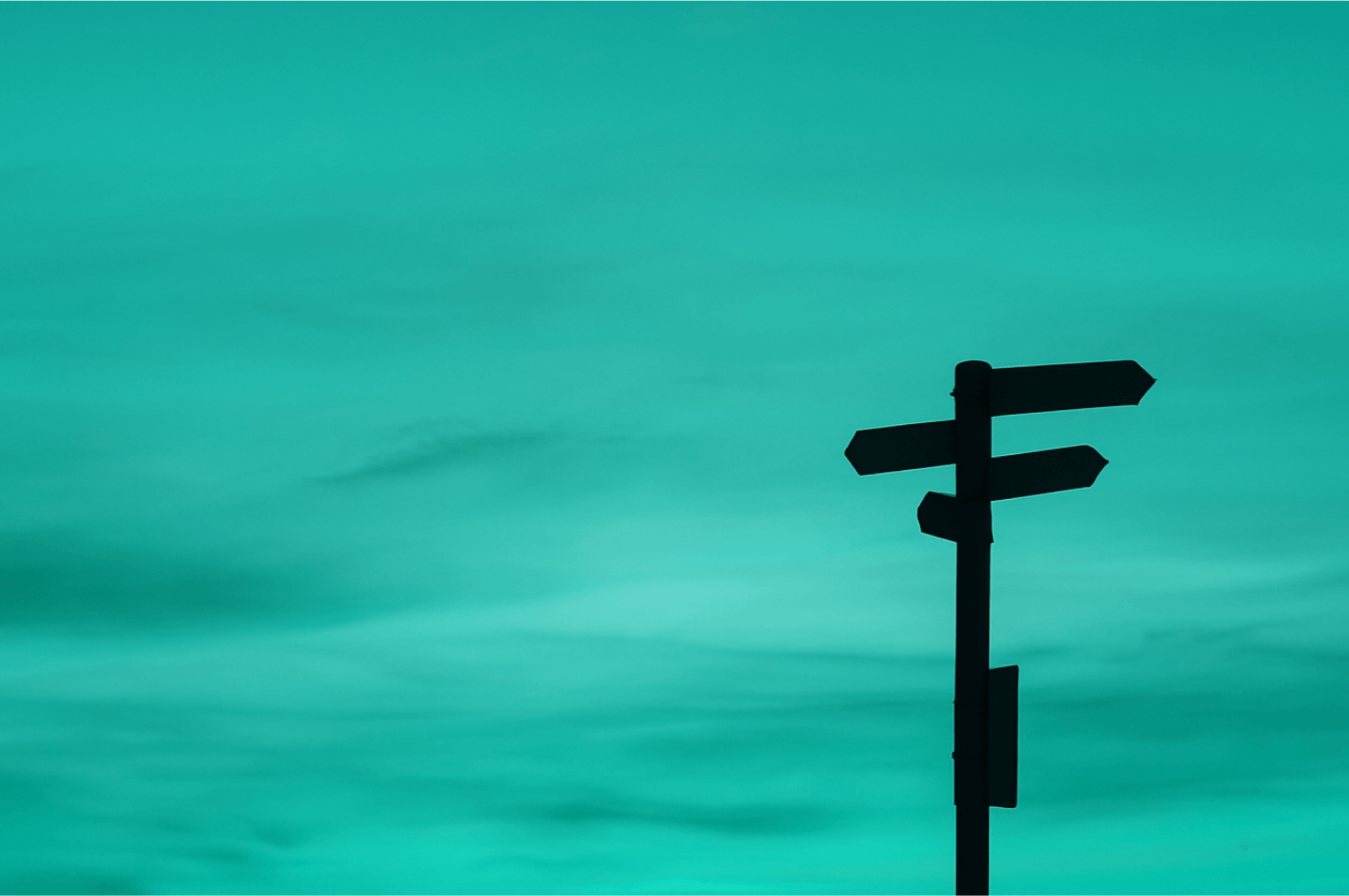 A signpost on a teal background that signifies taking a direction around investing